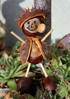 a figurine sitting on top of a plant