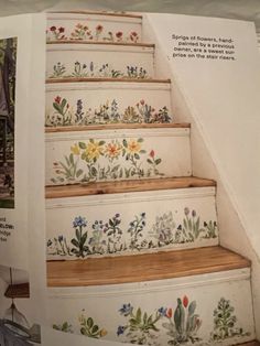 the stairs are painted with flowers and plants on them, as well as an advertise