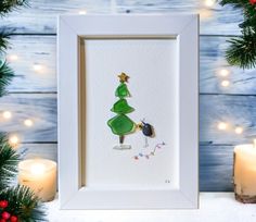 a christmas card with a green tree on it and a lit candle next to it