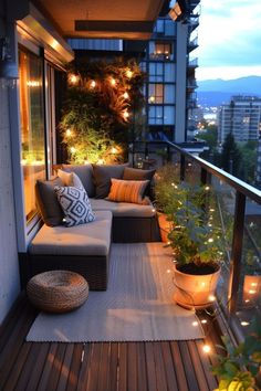 the balcony is decorated with lights and plants on it's sides, along with an outdoor seating area