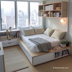 a bed sitting in the middle of a bedroom next to a book shelf filled with books