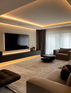 a living room with couches and a flat screen tv mounted on the wall above it