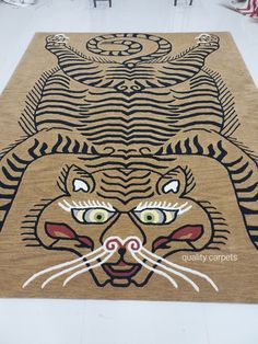 a rug with an image of a tiger's face on it and eyes drawn onto the floor