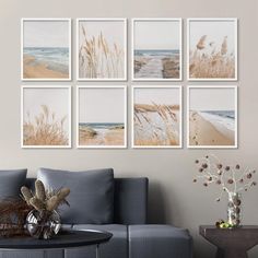 a living room filled with furniture and pictures hanging on the wall above a coffee table