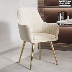 a white chair sitting in front of a book shelf