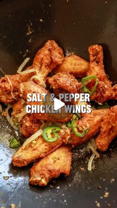 chicken wings in a frying pan with peppers and onions on the side that says salt & pepper chicken wings