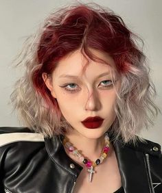 a woman with red hair wearing a black leather jacket and beaded choker necklace