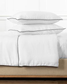 three white pillows stacked on top of each other