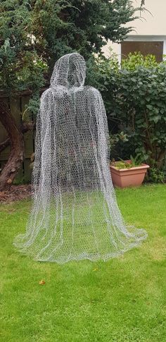 a sculpture in the shape of a person with a net covering it's face