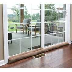 an open sliding glass door leading to a patio