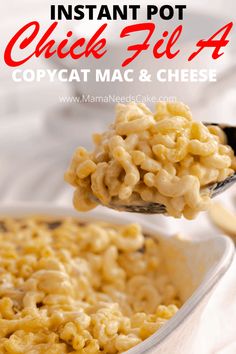 a spoon full of macaroni and cheese being lifted from a casserole dish