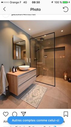 a bathroom with a sink, mirror and shower stall in it's own area