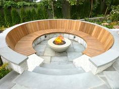 an outdoor fire pit with benches around it