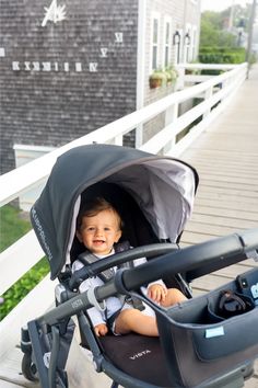 a small child sitting in a stroller