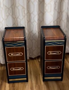 two brown and black nightstands sitting next to each other on a hard wood floor