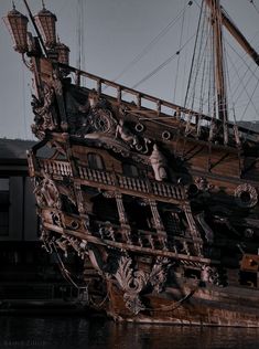 an old wooden pirate ship in the water