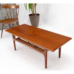 a wooden table sitting next to a potted plant