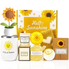 sunflowers, candles, and other items are arranged in front of a yellow box