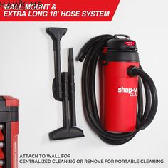 a red and black vacuum is next to other items on the wall with extra long hose system