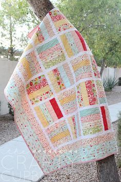 an image of a quilt hanging from a tree