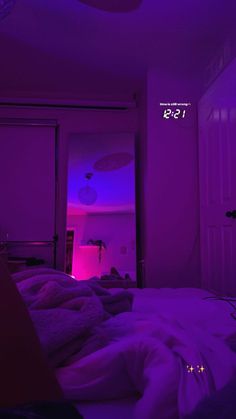 an image of a bedroom with purple lighting