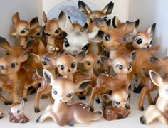 a group of deer figurines sitting next to each other