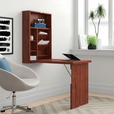 an office with a chair, desk and bookshelf in front of a window