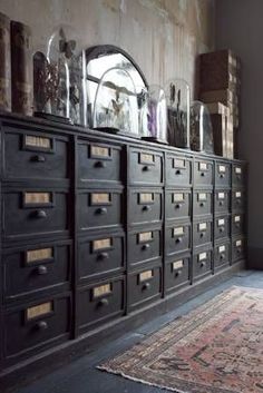 an old dresser with lots of drawers and glass vases on it's sides