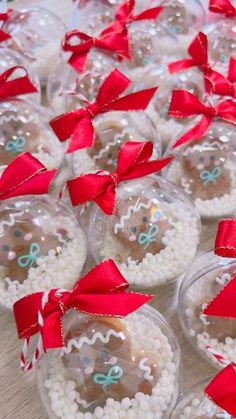 christmas baubles with red bows on them are arranged in glass balls and snow flakes