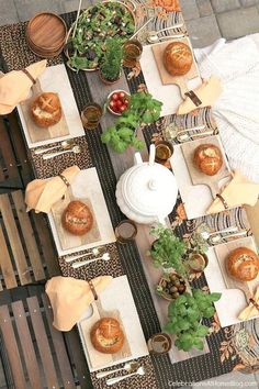 an overhead view of a table with breads and other food on it, along with potted plants