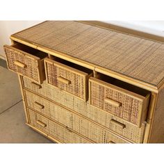 a wicker dresser with three drawers on top