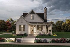 a white house with flowers in the front yard and steps leading up to it's entrance