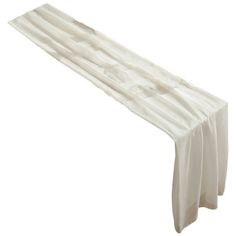 a white table runner with pleated edges