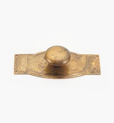 an old brass door handle with a ball on it