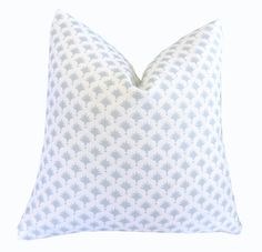 a blue and white pillow on a white background