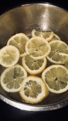 sliced lemons are in a silver bowl on the stove top, ready to be cooked