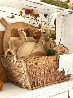 a wicker basket filled with cooking utensils on top of a white mantle