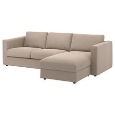 a beige sectional couch sitting on top of a white floor