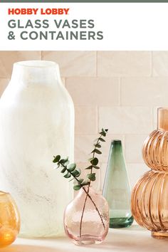 glass vases and containers sitting on a counter top with text overlay that reads hobby lobby glass vases & containers