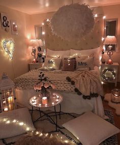 a bedroom decorated with lights and pillows