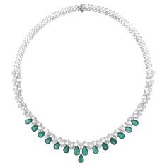 Step into the realm of timeless sophistication with our Pear Zambian Emerald Gemstone Choker Necklace, a pinnacle of luxury and elegance. Crafted with exquisite detail and finesse, this mesmerizing piece is designed to captivate and enchant. Item Code :- SEN-51270 Gross Wt. :- 35.92 gm 18k White Gold Wt. :- 30.75 gm Natural Diamond Wt. :- 12.39 Ct. ( AVERAGE DIAMOND CLARITY SI1-SI2 & COLOR H-I ) Emerald Wt. :- 13.48 Ct. Necklace Length :- 16 Inches Long ✦ Sizing ..................... We can adjust most items to fit your sizing preferences. Most items can be made to any size and length. Please leave a note at checkout or contact us via 1stDibs conversation. Even after purchasing the item, you can still ask us to adjust the size or length. We will try our best to fix it if it is possible. ✦ Gemstone Choker Necklace, Gemstone Choker, Necklace Diamond, Zambian Emerald, Colored Stone, Emerald Necklace, Large Gift, Antique Necklace, White Gold Jewelry