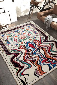 an area rug in the middle of a living room with a bicycle parked next to it