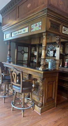 an old fashioned wooden bar with stools