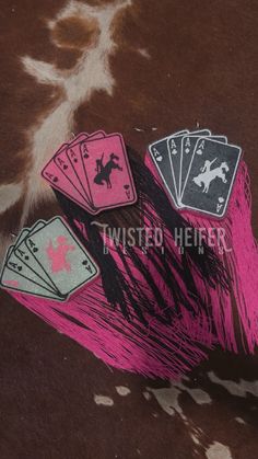 four playing cards are placed on top of a cowhide print background with the words twisted here written below them