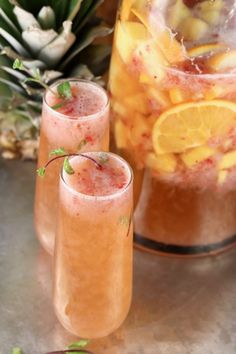 two glasses filled with champagne punch on top of a table