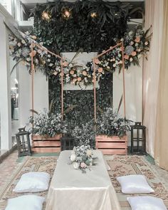 an indoor wedding setup with flowers and greenery