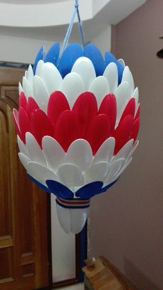 a red, white and blue balloon hanging from a ceiling