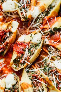 a close up view of some pasta shells with sauce and cheese