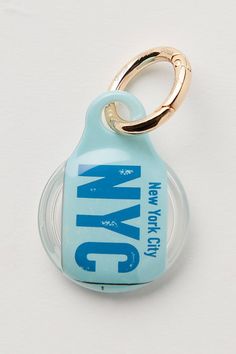 a keychain that is shaped like a bottle with the word nyc on it