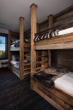 there are bunk beds in this room with wood walls and flooring on the other side